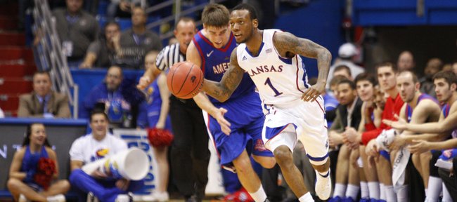 Kansas guard Naadir Tharpe pushes the ball up the court past American center Tony Wroblicky during the second half on Saturday, Dec. 29, 2012 at Allen Fieldhouse.