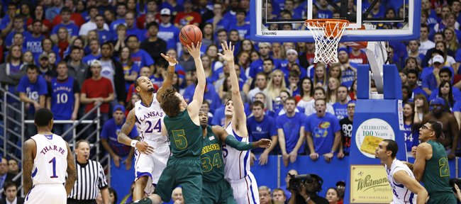 Kansas players Travis Releford (24) and Jeff Withey get in the face of Baylor guard Brady Heslip during the first half on Monday, Jan. 14, 2013 at Allen Fieldhouse.