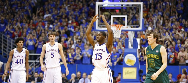 Kansas guard Elijah Johnson raises up the crowd after a Jayhawk bucket during the first half on Monday, Jan. 14, 2013 at Allen Fieldhouse. At right is Baylor guard Brady Heslip.