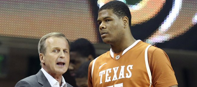 Texas men's basketball coach Rick Barnes, left, talks with Cameron Ridley in the first half of a NCAA college basketball game against Baylor, Saturday, Jan. 5, 2013, in Waco, Texas. 