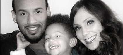 Kansas University senior Travis Releford, left, poses for a family portrait with 2-year-old son T.J. and girlfriend Jennifer Covell. Travis grew up without his father — in jail for second-degree murder — and vowed Travis Junior won’t suffer the same fate.