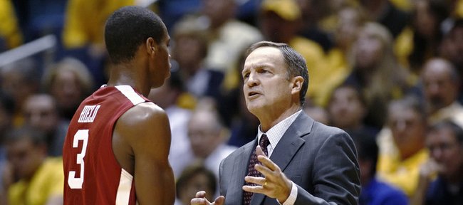 Oklahoma coach Lon Kruger speaks with Buddy Hield during a second-half break in an NCAA college basketball game against West Virginia on Saturday, Jan. 5, 2013, in Morgantown, W.Va. Oklahoma won 67-57.