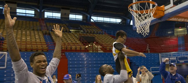 Kansas guard Ben McLemore throws his hands up in celebration after teammate Rio Adams helps camper Austin Bouahome dunk the ball during the Wilt Chamberlain Special Olympics Kansas Basketball Clinic held Sunday, Feb. 3, 2013 at Allen Fieldhouse.