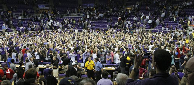 TCU fans flood the floor of the Daniel-Meyer Coliseum after the Horned Frogs defeated the Jayhawks, 62-55, Wednesday at TCU in Fort Worth, Texas.