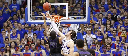 Kansas center Jeff Withey blocks a shot by Kansas State guard Rodney McGruder during the first half on Monday, Feb. 11, 2013. Earlier in the game, Withey set a new KU career block record. 