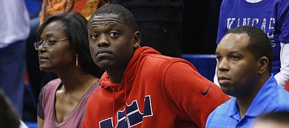 Kansas recruit Julius Randle sits behind the Kansas bench during the first half on Saturday, Feb. 16, 2013 at Allen Fieldhouse.