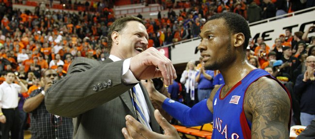 Kansas guard Naadir Tharpe gets a hug from head coach Bill Self after sinking a floater to give the Jayhawks the advantage over Oklahoma State with seconds remaining in double overtime on Wednesday, Feb. 20, 2013 at Gallagher-Iba Arena in Stillwater, Oklahoma.