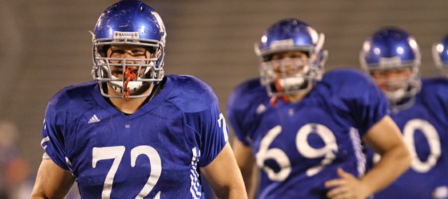 Senior offensive lineman Tanner Hawkinson leads his squad through warmups during a morning practice on Thursday, April 19, 2012 at Memorial Stadium. Nick Krug/Journal-World Photo