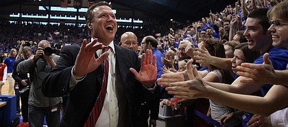 Kansas head coach Bill Self slaps hands with the fans following the Jayhawks' 87-86 overtime win over Missouri on Saturday, Feb. 25, 2012 at Allen Fieldhouse.