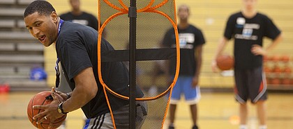 Former Kansas University forward Wayne Simien makes his way through a basketball drill at his Called to Greatness camp in this photo from 2011.