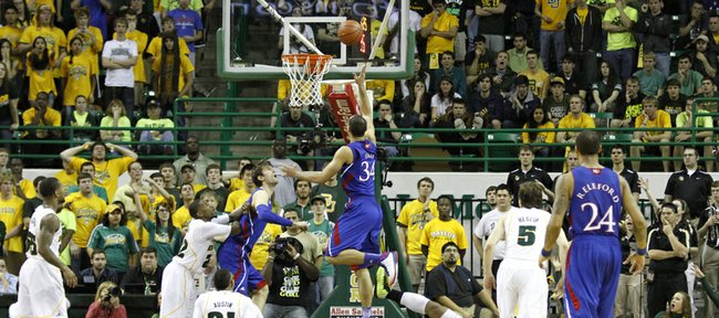 Perry Ellis (34) splits defenders for a layup in KU's 81-58 loss to the Baylor Bears Saturday in Waco.