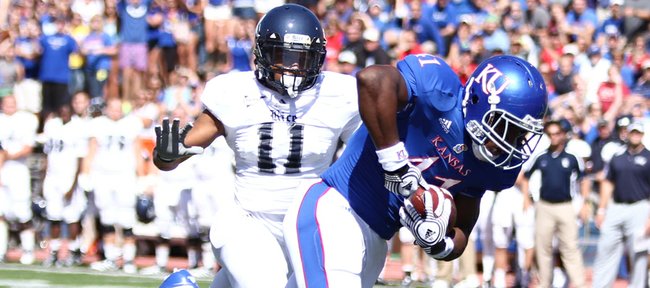 Kansas tight end Jimmay Mundine heads into the endzone for a touchdown past Rice corner back Malcolm Hill during the first quarter on Saturday, Sept. 8, 2012 at Memorial Stadium.