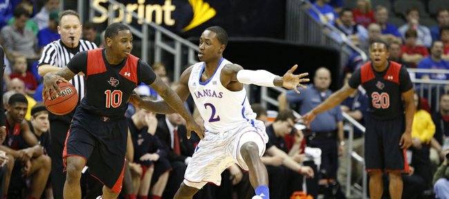 Kansas guard Rio Adams defends against Texas Tech guard Daylen Robinson during the second half of the second round of the Big 12 tournament on Thursday, March 14, 2013 at the Sprint Center in Kansas City, Missouri.