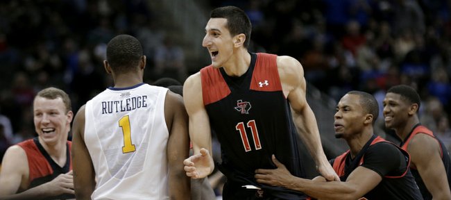 Texas Tech forward Dejan Kravic (11) celebrates with teammates after making the game-winning basket during an NCAA college basketball game against West Virginia in the Big 12 men's tournament Wednesday, March 13, 2013, in Kansas City, Mo. Texas Tech won 71-69.
