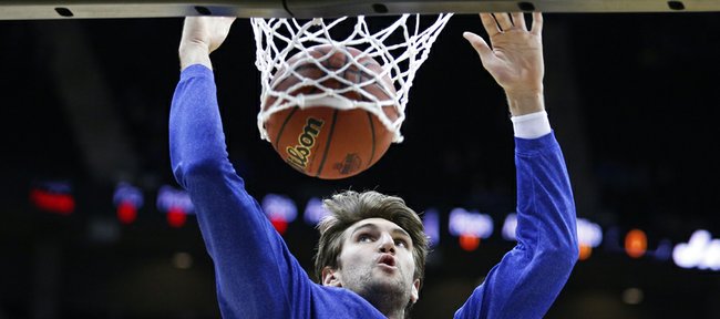 Kansas center Jeff Withey dunks during warmups prior to tipoff against Kansas State in the Big 12 tournament championship on Saturday, March 16, 2013 at the Sprint Center in Kansas City, Mo.
