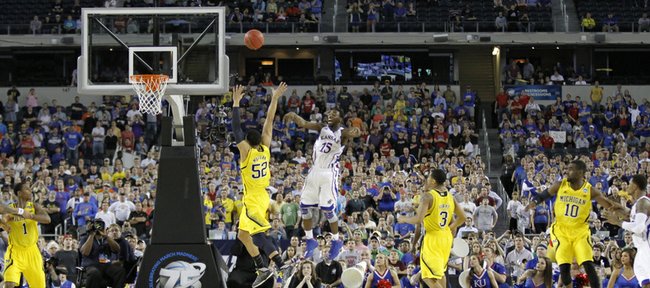 With only a few second on the clock and down by two points Elijah Johnson passes out to Naadir Tharpe for a last three-point attempt that missed leaving the Jayhawks with a 87-85 loss to the University of Michigan, Friday, March 29, 2013, at Cowboys Stadium, in Arlington, TX.
