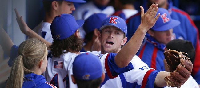 Kansas shortstop Kevin Kuntz, front, facing, bumps chests with Junior Mustain after turning a double play to get the Jayhawks out of the second inning with bases loaded on Friday, April 5, 2013 at Hoglund Ballpark.