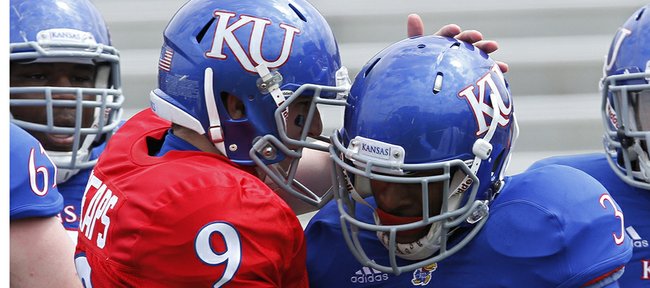 Kansas quarterback Jake Heaps gives KU running back/receiver Tony Pierson a pat on his helmet after Pierson scored the first touchdown on Saturday, April 13, 2013 during the KU football spring game. The Blue team defeated the White team, 34-7.