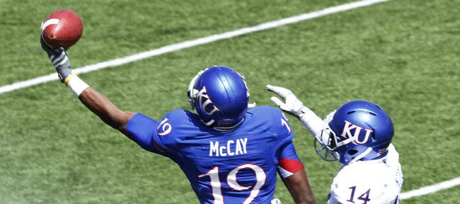 Kansas Blue team receiver Justin McCay makes a one-hand catch against the White team'ss Nasir Moore on Saturday, April 13, 2013, at the KU football spring game. The Blue team won, 34-7.