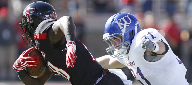 Kansas linebacker Ben Heeney chases down Texas Tech receiver Eric Ward after a catch during the first quarter on Saturday, Nov. 10, 2012 at Jones AT&T Stadium in Lubbock, Texas.