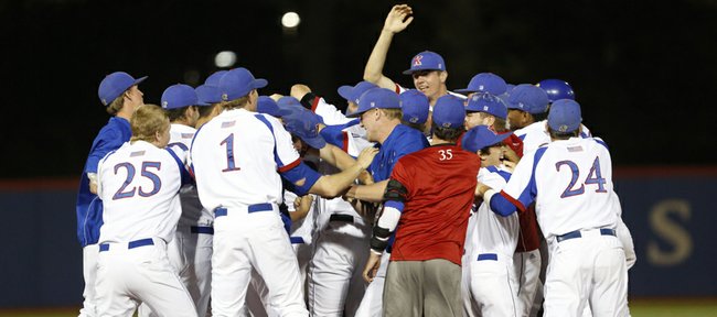 The Jayhawks mob teammate Dakota Smith after Smith's eleventh-inning single drove in teammate Michael Suiter for the win against Wichita State, Tuesday, April 30, 2013 at Hoglund Ballpark. Nick Krug/Journal-World Photo