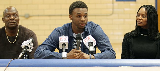 Huntington Prep basketball player Andrew Wiggins, center, flanked by his parents Mitchell Wiggins and Marita Payne-Wiggins, as he announces his commitment to the University of Kansas during a ceremony, Tuesday, May 14, 2013, at St. Joseph High School in Huntington W.Va. The Canadian star, a top prospect, averaged 23.4 points and 11.2 rebounds per game this season for West Virginia's Huntington Prep. 
