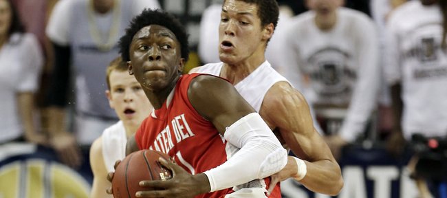 Mater Dei forward Stanley Johnson, left, spins around Archbishop Mitty forward Aaron Gordon as he goes to the basket during the second quarter of the CIF boys open division state high school basketball championship game in Sacramento, Calif., Saturday, March 23, 2013.
