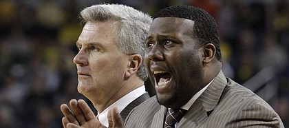 Illinois head coach Bruce Weber, left, and assistant coach Jerrance Howard watch from the sidlines during the second half of a game against Michigan in this 2012 Associated Press file photo. Though nothing is official, Howard is likely to replace Kansas University assistant coach Joe Dooley, KU coach Bill Self confirmed Wednesday.