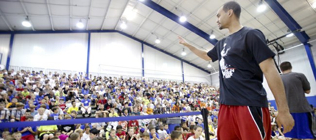 Kansas University forward Perry Ellis waves to a gathering of basketball campers after giving a pep talk about work ethic and maintaining good grades during Bill Self’s basketball camp, Tuesday, June 11, 2013, at the Horejsi Center. 