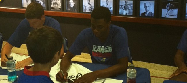 Kansas freshman Andrew Wiggins signs an autograph at the Bill Self basketball camp on Sunday, June 16, 2013, at the Booth Family Hall of Athletics.