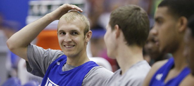 Kansas guard Conner Frankamp smiles while talking with teammate Tyler Self on the bench prior to a scrimmage on Wednesday, June 12, 2013, at the Horejsi Center.