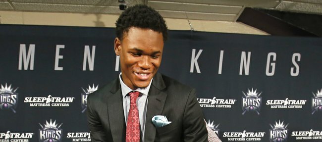 Sacramento first-round draft pick Ben McLemore picks up his jersey after a news conference Monday, July 1, 2013, in Sacramento, Calif.
