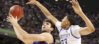 Kansas center Jeff Withey looks for a shot as Kentucky forward Anthony Davis reaches in to defend during the first half of the national championship on Monday, April 2, 2012 in New Orleans.