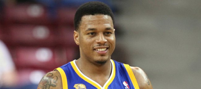 Golden State Warriors' Andris Biedrins, of Latvia, left, and Brandon Rush smile as they walk down court during a timeout in the fourth quarter against the Sacramento Kings in an NBA basketball game in Sacramento, Calif., March 13, 2012. The Warriors won 115-89.