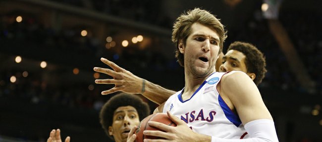 Kansas center Jeff Withey pulls a rebound from North Carolina forward James Michael McAdoo during the first half, Sunday, March 24, 2013 at the Sprint Center in Kansas City, Mo. In back is Kansas forward Kevin Young.
