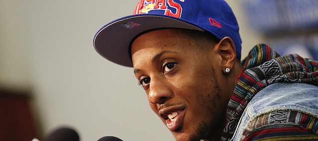 Kansas great Mario Chalmers talks with media members prior to tipoff against Texas on Saturday, Feb. 16, 2013 at Allen Fieldhouse.