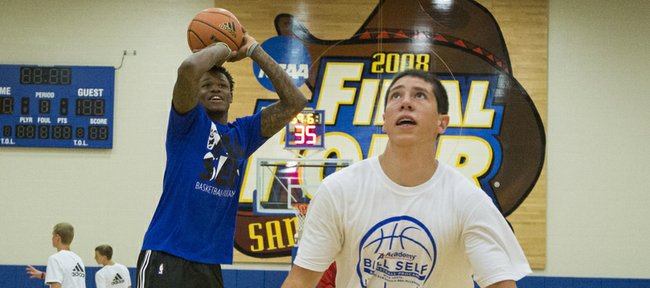 Former Kansas University player Ben McLemore eliminates Dakota Marriott, 17, Smithville, Mo., during game of knockout as other campers watch during the Bill Self basketball camp Saturday.