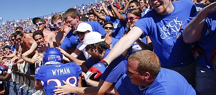 Kansas kicker Matthew Wyman is mobbed by the Kansas student section after his walk-off 52-yard fieldgoal gave the Jayhawks the win over Louisiana Tech on Saturday, Sept. 21, 2013 at Memorial Stadium.