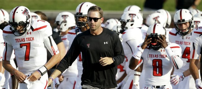 Texas Tech football coach Kliff Kingsbury runs on the field with his team before the Red Raiders’ 41-23 victory over SMU on Aug. 30 in Dallas. Kingsbury, the former Tech and New England Patriots (backup) QB, will face Kansas at 11 a.m. Saturday at Memorial Stadium.