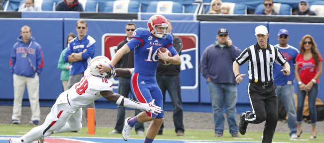 Kansas punter Trevor Pardula takes off on a fourth-down run on a fake punt against Texas Tech during the second quarter on Saturday, Oct. 5, 2013 at Memorial Stadium. Pardula was stopped on the play by Tech linebacker Micah Aw to give the Red Raiders the ball deep in Jayhawk territory.