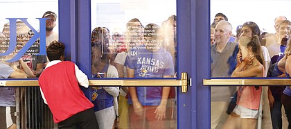 Kansas fans unable to enter pile up at an entrance on the north side of Allen Fieldhouse after the maximum amount had been let in for Late Night in the Phog, Friday, Oct. 4, 2013 at Allen Fieldhouse.