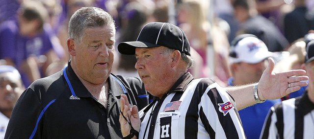 Kansas coach Charlie Weis works on an official to make his point that a TCU player that was out of bounds during Saturday's game in Fort Worth, Texas.