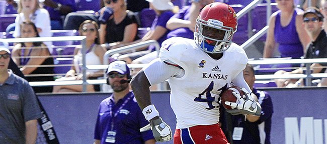 Kansas tight end Jimmay Mundine (41) eludes TCU's Sam Carter (17) for a touchdown in the second half of TCU's 27-17 victory over KU on Oct. 12, 2013.