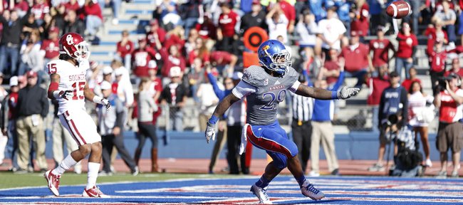 Kansas running back James Sims flips the ball to an official after scoring a touchdown against Oklahoma during the second quarter on Saturday, Oct. 19, 2013 at Memorial Stadium.