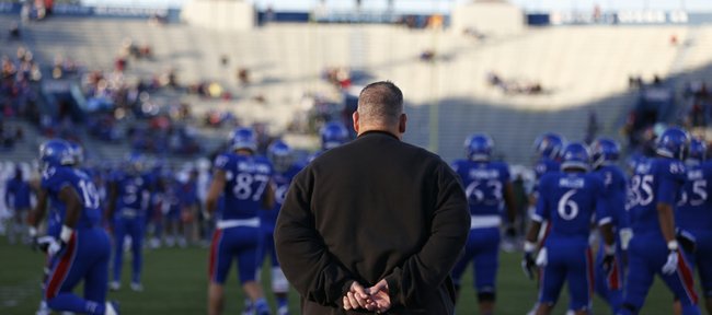 Kansas head coach Charlie Weis watches his team warm up for Baylor on Saturday, Oct. 26, 2013.