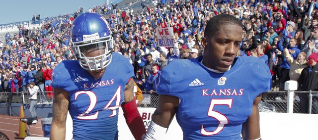 Deflated Kansas defenders Greg Brown (5) and Bradley McDougald (24) make their way off the field following the Jayhawks' heartbreaking 21-17 loss to Texas on Saturday, Oct. 27, 2012 at Memorial Stadium.