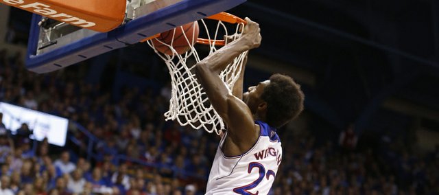 Kansas forward Andrew Wiggins delivers a dunk over Pittsburg State forward Trevor Gregory during the first half of an exhibition game on Tuesday, Oct. 29, 2013 at Allen Fieldhouse.
