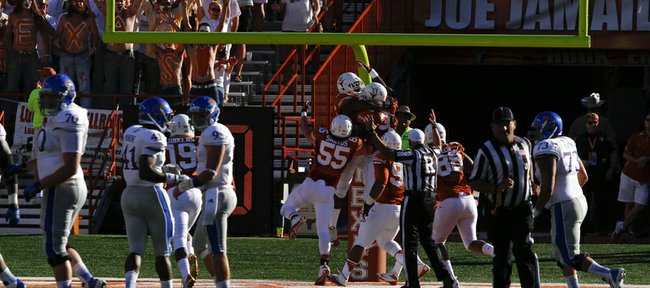 Texas players celebrate in the endzone with defensive tackle Chris Whaley after Whaley recovered a fumble by Kansas quarterback Jake Heaps and ran it back for a touchdown during the third quarter on Saturday, Nov. 2, 2013 at Darrell K. Royal Stadium in Austin, Texas.