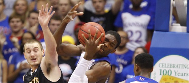 Kansas center Joel Embiid yanks a rebound away from Fort Hays State forward Marty Wendel during the first half of an exhibition game on Tuesday, Nov. 5, 2013.