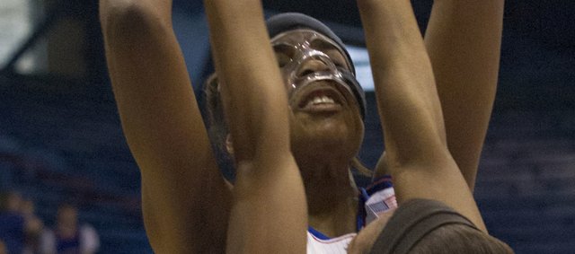 Kansas' Chelsea Gardner is harassed by Oral Roberts' Tysia Manuel (13) as she tries to get a shot off during their game Sunday afternoon at Allen Fieldhouse. The Jayhawks won their season opener, 84-62.